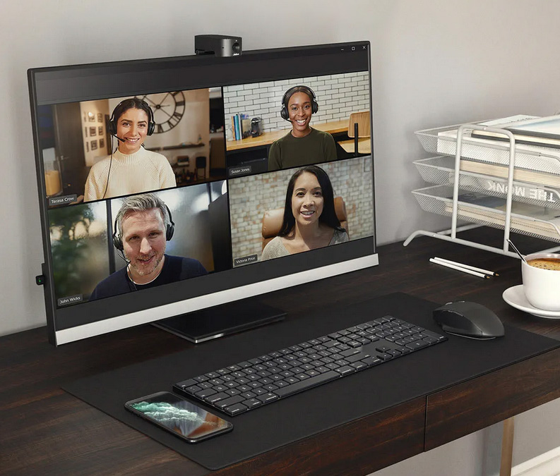 An image of a desktop computer with a PanaCast 20 camera mounted on top, the screen shows four video call participants