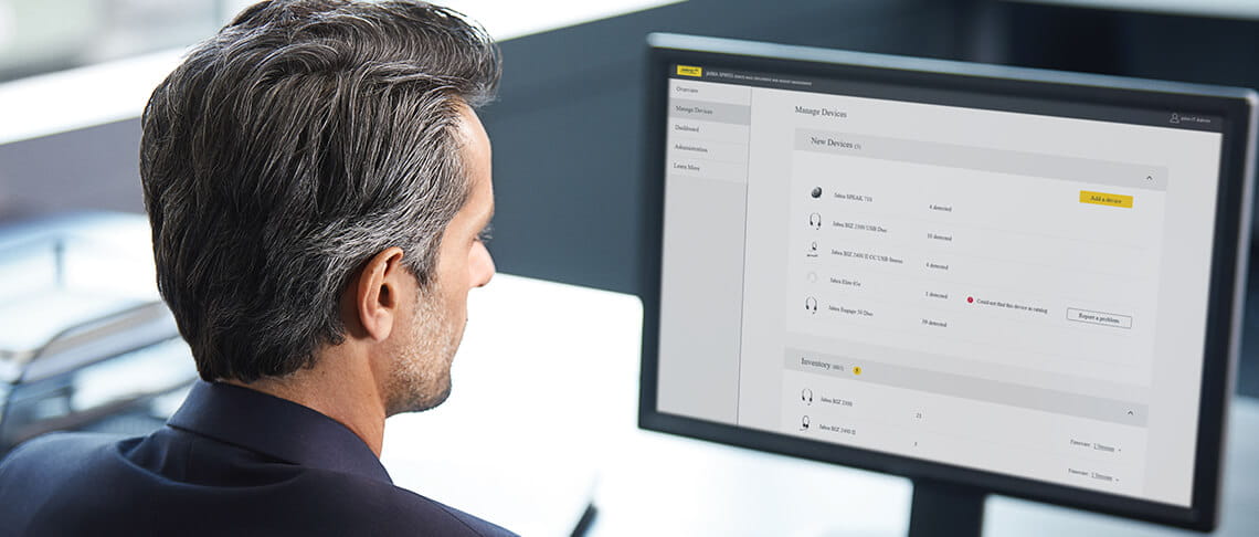 An image of a worker using the Jabra Room Insights app to review the deployed Jabra devices.